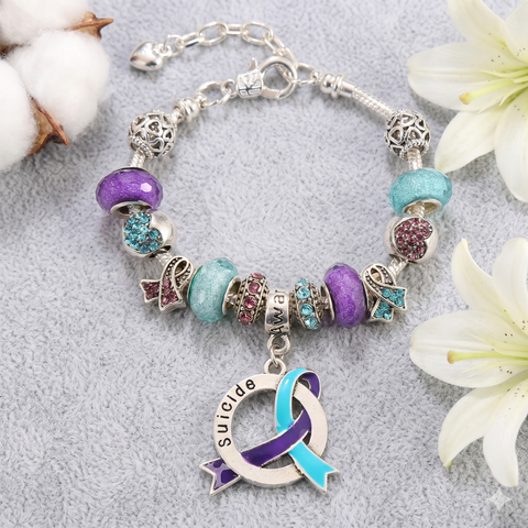 Suicide Awareness Luxury Charm Bracelet with teal and purple charms on white background – The Awareness Store
