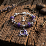 Fibromyalgia Awareness Luxury Charm Bracelet with purple and silver charms close-up