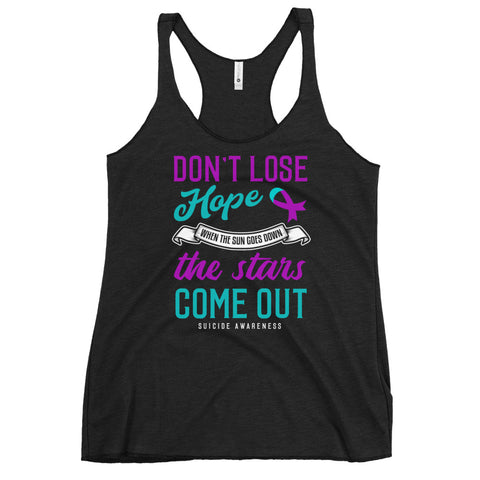Suicide awareness women's racerback tank top with "Don't Lose Hope" message, featuring pink ribbon design on a black fabric background.